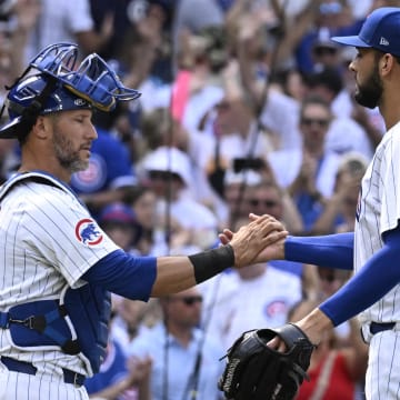 Jun 15, 2024; Chicago, Illinois, USA;  Chicago Cubs catcher Yan Gomes (15) and pitcher Tyson Miller (49) after the game against the St. Louis Cardinals  at Wrigley Field.