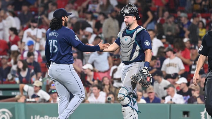 Jul 30, 2024; Boston, Massachusetts, USA; Seattle Mariners pitcher Andres Munoz (75) and catcher Cal Raleigh (29) celebrate beating the Boston Red Sox at Fenway Park. Mandatory Credit: Eric Canha-USA TODAY Sports