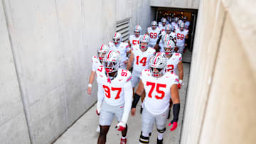 Ohio State Buckeyes defensive end Kenyatta Jackson Jr. (97) and Carson Hinzman (75) take the field with their teammates before the game against the Wisconsin Badgers at Camp Randall Stadium on Saturday, Oct. 18, 2025 in Madison, Wisconsin.