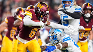 Detroit Lions cornerback Arthur Maulet tackles Washington Commanders kick returner Noah Igbinoghene.