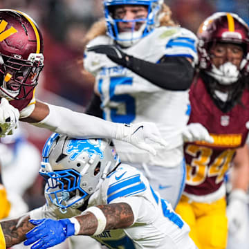 Detroit Lions cornerback Arthur Maulet tackles Washington Commanders kick returner Noah Igbinoghene.
