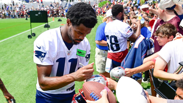 New England Patriots wide receiver Tyquan Thornton (11) signs autographs for fans at training camp  at Gillette Stadium.