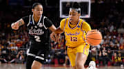 Mar 24, 2025; Los Angeles, California, USA; USC Trojans guard JuJu Watkins (12) drives to the basket past Mississippi State Bulldogs guard Jerkaila Jordan (2) during the first quieter of an NCAA Tournament second round game at Galen Center. Mandatory Credit: Robert Hanashiro-Imagn Images