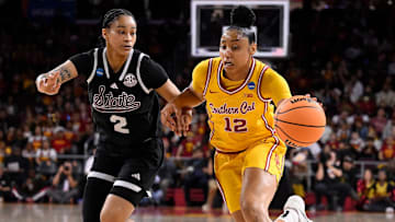 Mar 24, 2025; Los Angeles, California, USA; USC Trojans guard JuJu Watkins (12) drives to the basket past Mississippi State Bulldogs guard Jerkaila Jordan (2) during the first quieter of an NCAA Tournament second round game at Galen Center. Mandatory Credit: Robert Hanashiro-Imagn Images