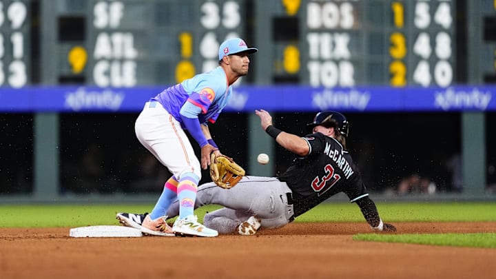 Aug 15, 2025; Denver, Colorado, USA; Arizona Diamondbacks outfielder Jake McCarthy (31) steals second on Colorado Rockies second baseman Tyler Freeman (2) in the fourth inning at Coors Field. Mandatory Credit: Ron Chenoy-Imagn Images