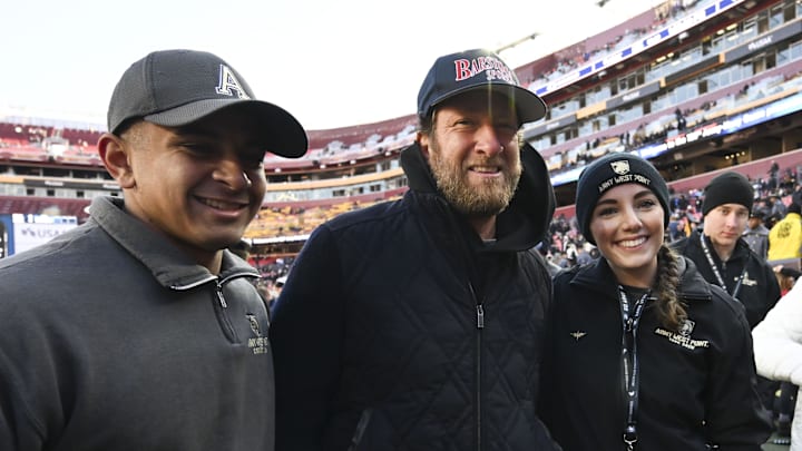Dec 14, 2024; Landover, Maryland, USA;  Dave Portnoy poses with solders before the between the Army Black Knights and the Navy Midshipmen  at Commanders Field. Mandatory Credit: Tommy Gilligan-Imagn Images