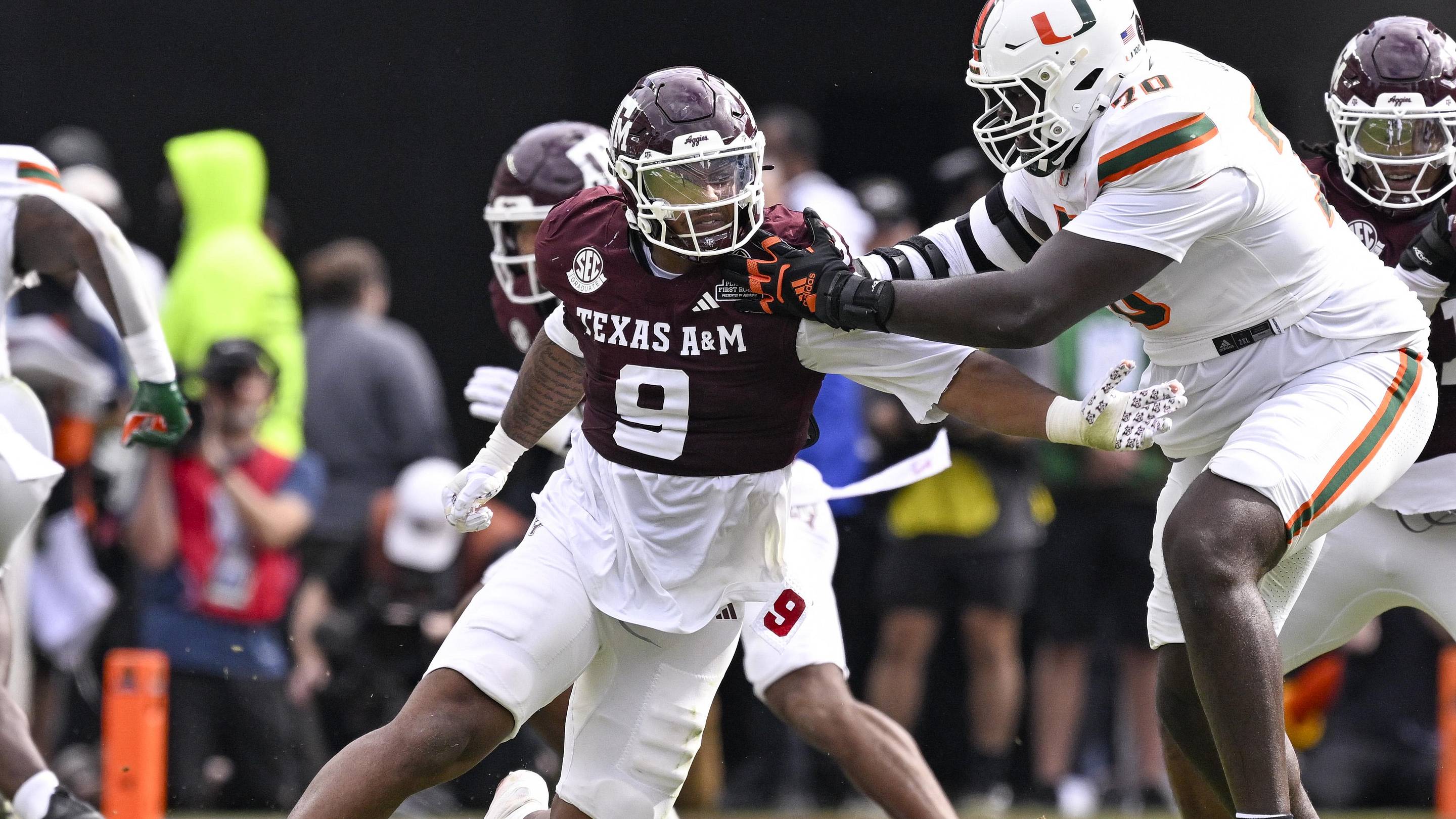 Texas A&M Aggies defensive end Cashius Howell rushes the line past Miami Hurricanes offensive lineman Markel Bell during the game between the Aggies and the Hurricanes at Kyle Field.