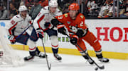 Mar 11, 2025; Anaheim, California, USA; Anaheim Ducks center Mason McTavish (23) skates against Washington Capitals center Aliaksei Protas (21) during the first period at Honda Center. Mandatory Credit: Jason Parkhurst-Imagn Images