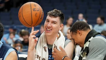 Grizzlies' Jake LaRavia (3) laughs with Desmond Bane (22) as he spins a basketball on his finger while they sit on the during open practice at FedExForum in Memphis, Tenn., on Sunday, October 6, 2024.