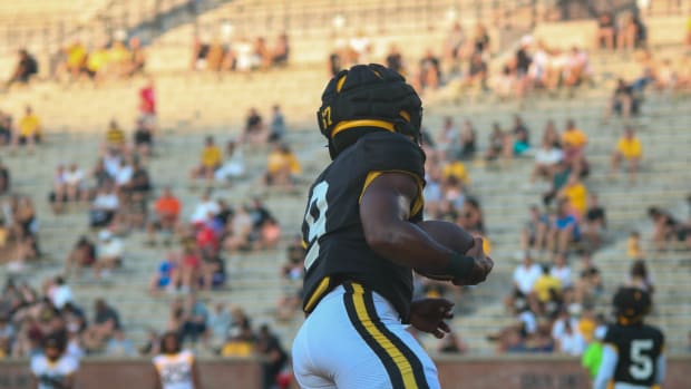 Missouri Tigers running back Marcus Carroll (9) warms up ahead of the the team's annual fan night practice.