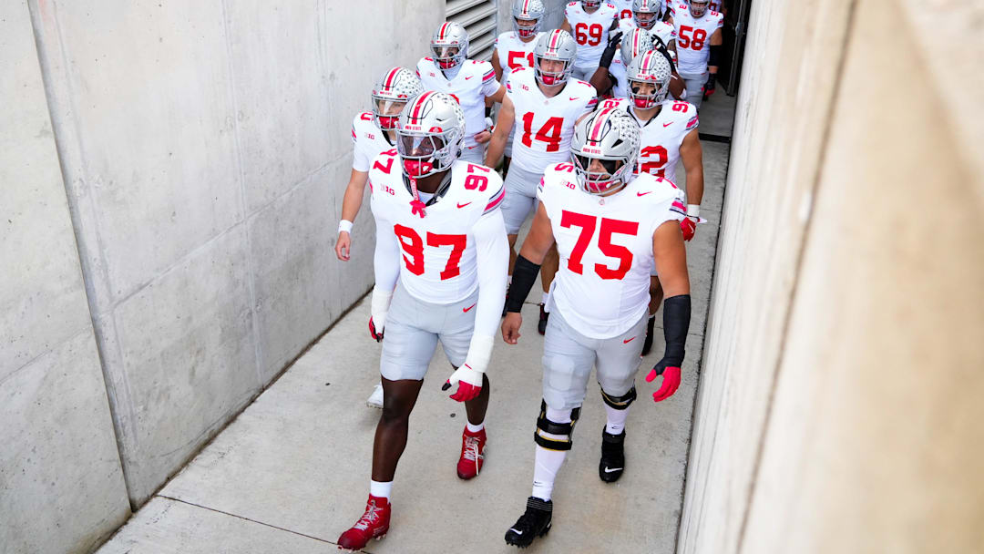 Ohio State Buckeyes defensive end Kenyatta Jackson Jr. (97) and Carson Hinzman (75) take the field with their teammates before the game against the Wisconsin Badgers at Camp Randall Stadium on Saturday, Oct. 18, 2025 in Madison, Wisconsin.
