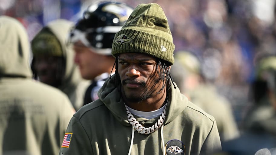 Lamar Jackson wearing a hat on the sideline.