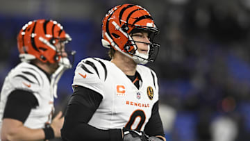 Nov 27, 2025; Baltimore, Maryland, USA;  Cincinnati Bengals quarterback Joe Burrow (9) adjust his gloves while running on the field before the game against the Baltimore Ravens at M&T Bank Stadium. Mandatory Credit: Tommy Gilligan-Imagn Images