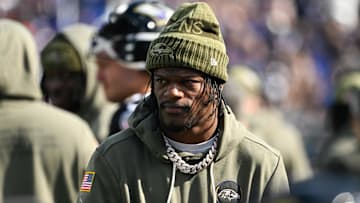 Oct 26, 2025; Baltimore, Maryland, USA; Baltimore Ravens quarterback Lamar Jackson (8) looks on from the sideline during the first quarter against the Chicago Bears at M&T Bank Stadium. Mandatory Credit: Tommy Gilligan-Imagn Images