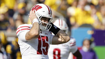 Oct 4, 2025; Ann Arbor, Michigan, USA;  Wisconsin Badgers quarterback Hunter Simmons (15) covers his ears in the first half against the Michigan Wolverines at Michigan Stadium. Mandatory Credit: Rick Osentoski-Imagn Images
