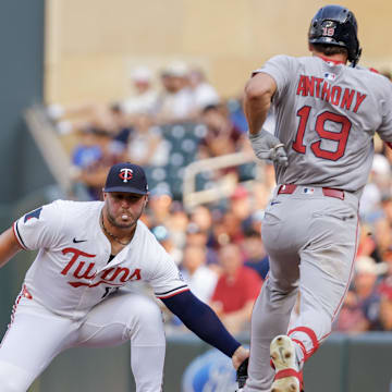 Jul 28, 2025; Minneapolis, Minnesota, USA; Minnesota Twins first baseman Ty France (13) cannot handle the errant throw by starting pitcher Simeon Woods Richardson (not pictured) that allows Boston Red Sox left fielder Roman Anthony (19) to advance to second base on his single in the first inning at Target Field. Mandatory Credit: Bruce Kluckhohn-Imagn Images