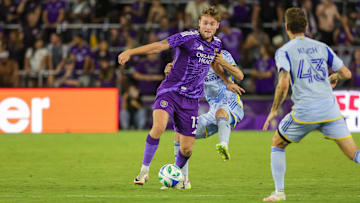 Apr 26, 2025; Orlando, Florida, USA; Orlando City forward Duncan McGuire (13) battles for the ball against Atlanta United defender Noah Cobb (24) during the second half at Inter&Co Stadium. Mandatory Credit: Mike Watters-Imagn Images