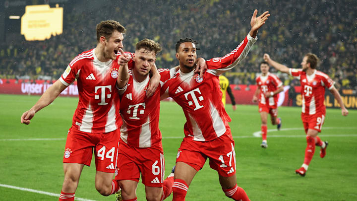 Bayern Munich players celebrating a goal against Borussia Dortmund on matchday 24 of the Bundesliga.