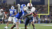 Nov 15, 2025; Durham, North Carolina, USA;  Duke Blue Devils cornerback Chandler Rivers (0) attempts to swat the ball from Virginia Cavaliers wide receiver Trell Harris (11) during the third quarter at Wallace Wade Stadium. Mandatory Credit: Zachary Taft-Imagn Images