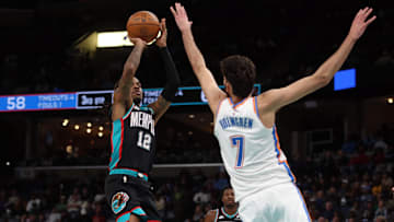 Nov 9, 2025; Memphis, Tennessee, USA; Memphis Grizzlies guard Ja Morant (12) shoots as Oklahoma City Thunder center Chet Holmgren (7) defends during the third quarter at FedExForum.