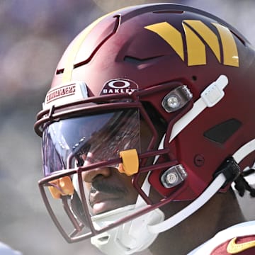 Washington Commanders quarterback Jayden Daniels stands on the sidelines during the second half against the Baltimore Ravens.