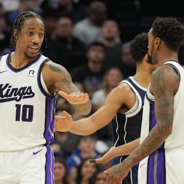 Dec 30, 2024; Sacramento, California, USA; Sacramento Kings forward DeMar DeRozan (10) talks with guard Malik Monk (right) during the second quarter against the Dallas Mavericks at Golden 1 Center. Mandatory Credit: Darren Yamashita-Imagn Images