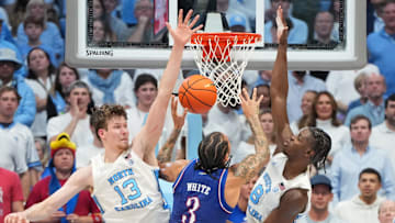 Nov 7, 2025; Chapel Hill, North Carolina, USA;  Kansas Jayhawks guard Tre White (3) shoots as North Carolina Tar Heels center Henri Veesaar (13) and forward Caleb Wilson (8) defend in the second half at Dean E. Smith Center. Mandatory Credit: Bob Donnan-Imagn Images