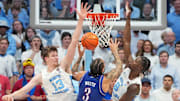 Nov 7, 2025; Chapel Hill, North Carolina, USA;  Kansas Jayhawks guard Tre White (3) shoots as North Carolina Tar Heels center Henri Veesaar (13) and forward Caleb Wilson (8) defend in the second half at Dean E. Smith Center. Mandatory Credit: Bob Donnan-Imagn Images