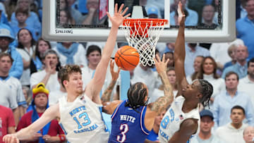 Nov 7, 2025; Chapel Hill, North Carolina, USA;  Kansas Jayhawks guard Tre White (3) shoots as North Carolina Tar Heels center Henri Veesaar (13) and forward Caleb Wilson (8) defend in the second half at Dean E. Smith Center. Mandatory Credit: Bob Donnan-Imagn Images
