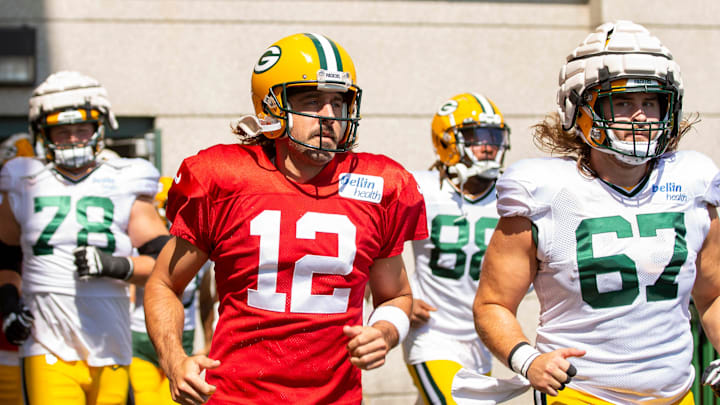 Green Bay Packers quarterback Aaron Rodgers (12) runs onto the practice field with teammates, tackle/guard Cole Van Lanen (78), wide receiver Juwann Winfree (88) and center Jake Hanson (67) during training camp on Tuesday, Aug. 2, 2022, at Ray Nitschke Field in Ashwaubenon, Wis. Samantha Madar/USA TODAY NETWORK-Wis.

Gpg Packers Training Camp 08022022 0008