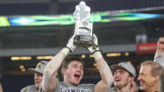Dec 29, 2022; Bronx, NY, USA; Minnesota Golden Gophers defensive back Coleman Bryson (16) holds the MVP trophy after the game against the Syracuse Orange in the 2022 Pinstripe Bowl at Yankee Stadium. Mandatory Credit: Vincent Carchietta-USA TODAY Sports