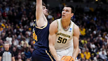 March 20, 2025; Denver, CO, USA; Michigan Wolverines center Vladislav Goldin (50) looks to shoot against UC San Diego Tritons forward Nordin Kapic (24) during the first half at Ball Arena. Mandatory Credit: Ron Chenoy-Imagn Images