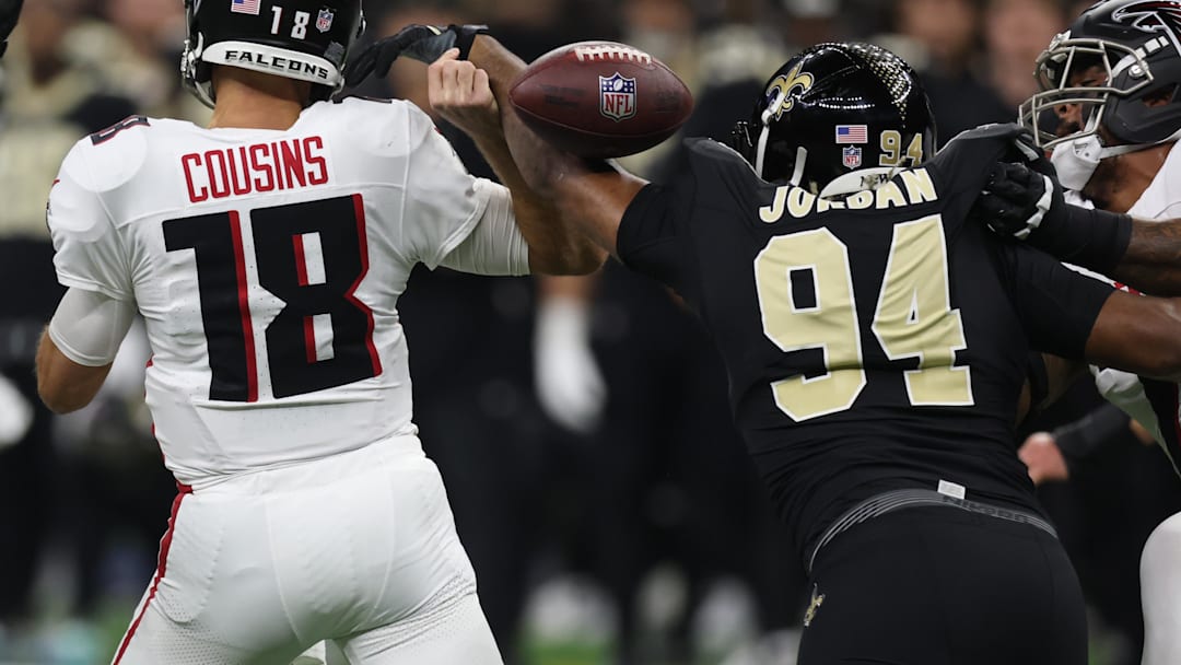 Nov 23, 2025; New Orleans, Louisiana, USA; Atlanta Falcons quarterback Kirk Cousins (18) is stripped of the ball by. New Orleans Saints defensive end Cameron Jordan (94) during the first half at Caesars Superdome. Mandatory Credit: Stephen Lew-Imagn Images