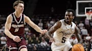 Nov 18, 2025; College Station, Texas, USA; Texas A&M Aggies guard Jacari Lane (5) drives to the basket as Montana Grizzlies guard Tyler Isaak (8) defends during the first half at Reed Arena. Mandatory Credit: Maria Lysaker-Imagn Images 