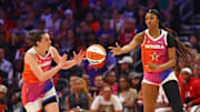Jul 20, 2024; Phoenix, AZ, USA; Team WNBA forward Angel Reese (5) passes the ball to Team WNBA guard Caitlin Clark (22) during the first half against the USA Women's National Team at Footprint Center.
