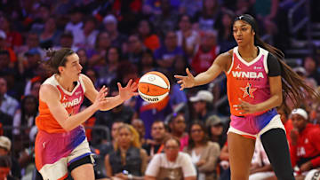 Jul 20, 2024; Phoenix, AZ, USA; Team WNBA forward Angel Reese (5) passes the ball to Team WNBA guard Caitlin Clark (22) during the first half against the USA Women's National Team at Footprint Center.