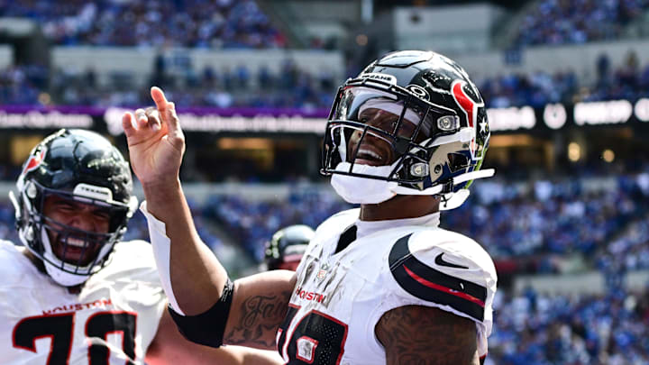 Sep 8, 2024; Indianapolis, Indiana, USA; Houston Texans running back Joe Mixon (28) celebrates a touchdown in front of Houston Texans center Juice Scruggs (70) during the second half against the Indianapolis Colts at Lucas Oil Stadium. Mandatory Credit: Marc Lebryk-Imagn Images