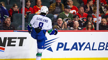 Mar 12, 2025; Calgary, Alberta, CAN; Vancouver Canucks right wing Conor Garland (8) celebrates his goal against the Calgary Flames during the shootout period at Scotiabank Saddledome. Mandatory Credit: Sergei Belski-Imagn Images