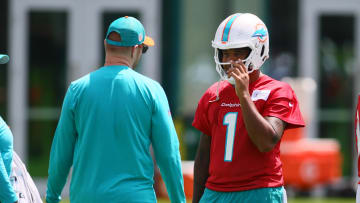 Jun 4, 2024; Miami Gardens, FL, USA; Miami Dolphins quarterback Tua Tagovailoa (1) talks to quarterback coach Darrell Bevell during mandatory minicamp at Baptist Health Training Complex. Mandatory Credit: Sam Navarro-USA TODAY Sports