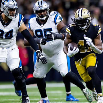 Dec 10, 2023; New Orleans, Louisiana, USA; New Orleans Saints running back Alvin Kamara (41) runs against Carolina Panthers defensive end Henry Anderson (94) during the first half at the Caesars Superdome. Mandatory Credit: Stephen Lew-USA TODAY Sports