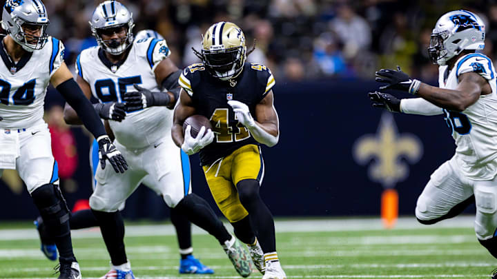 Dec 10, 2023; New Orleans, Louisiana, USA; New Orleans Saints running back Alvin Kamara (41) runs against Carolina Panthers defensive end Henry Anderson (94) during the first half at the Caesars Superdome. Mandatory Credit: Stephen Lew-USA TODAY Sports