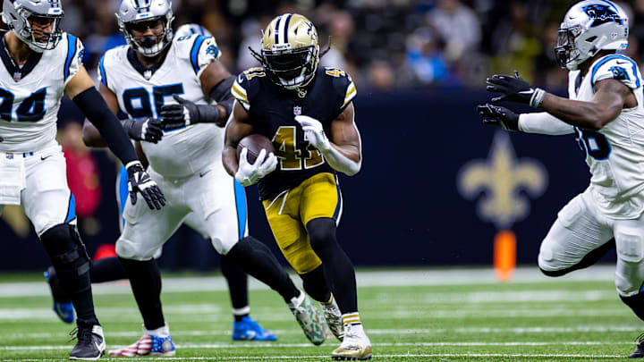 Dec 10, 2023; New Orleans, Louisiana, USA; New Orleans Saints running back Alvin Kamara (41) runs against Carolina Panthers defensive end Henry Anderson (94) during the first half at the Caesars Superdome. Mandatory Credit: Stephen Lew-Imagn Images