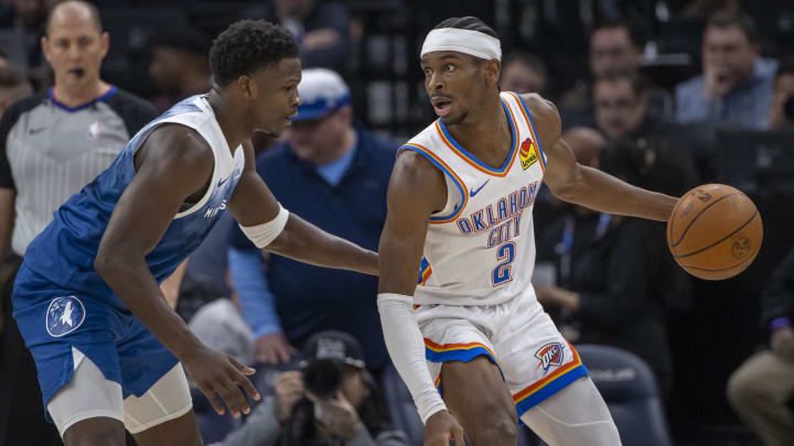 Jan 20, 2024; Minneapolis, Minnesota, USA; Oklahoma City Thunder guard Shai Gilgeous-Alexander (2) looks to pass the ball as Minnesota Timberwolves guard Anthony Edwards (5) plays defense in the second half at Target Center. Mandatory Credit: Jesse Johnson-USA TODAY Sports