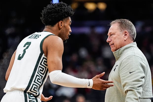 Michigan State player Jaden Atkins talks with Spartans coach Tom Izzo. 