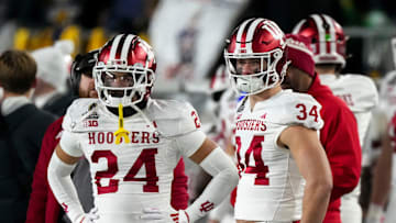 Indiana Hoosiers defensive back Bryson Bonds (24) and Indiana Hoosiers linebacker Jeff Utzinger (34) watch the second half of a game between the Indiana Hoosiers and the Notre Dame Fighting Irish in first round of the College Football Playoff on Saturday, Dec. 21, 2024, in South Bend. Notre Dame defeated Indiana 27-17.