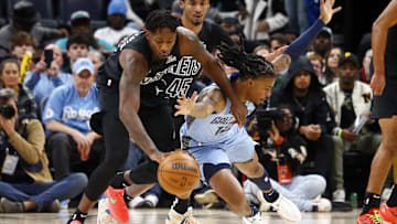 Dec 13, 2024; Memphis, Tennessee, USA; Brooklyn Nets forward Dorian Finney-Smith (28) and Memphis Grizzlies guard Ja Morant (12) battle for a loose ball during the first quarter at FedExForum. Mandatory Credit: Petre Thomas-Imagn Images