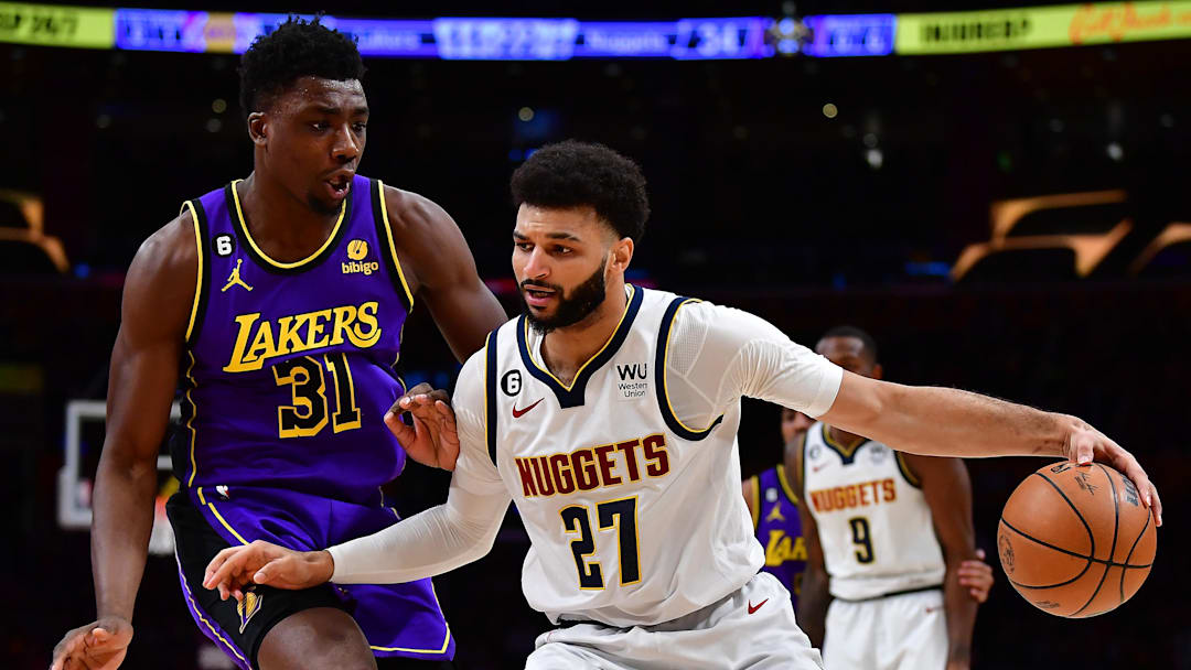 Dec 16, 2022; Los Angeles, California, USA; Denver Nuggets guard Jamal Murray (27) controls the ball against Los Angeles Lakers center Thomas Bryant (31)  during the first half at Crypto.com Arena. Mandatory Credit: Gary A. Vasquez-Imagn Images