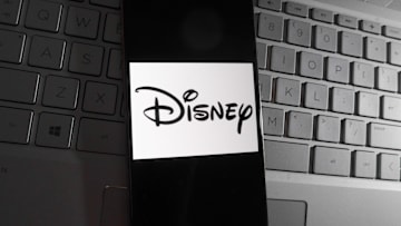 In this photo illustration, Disney logo is displayed on a...