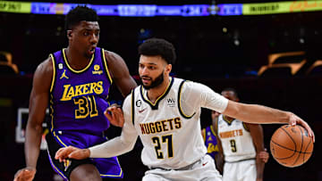 Dec 16, 2022; Los Angeles, California, USA; Denver Nuggets guard Jamal Murray (27) controls the ball against Los Angeles Lakers center Thomas Bryant (31)  during the first half at Crypto.com Arena. Mandatory Credit: Gary A. Vasquez-Imagn Images