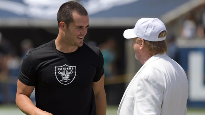 Aug 18, 2018; Los Angeles, CA, USA; Oakland Raiders  owner Mark Davis (right) talks with quarterback Derek Carr during a preseason game against the Los Angeles Rams at Los Angeles Memorial Coliseum. Mandatory Credit: Kirby Lee-USA TODAY Sports